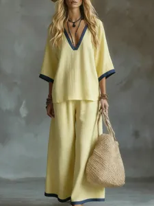 Summer two-piece yellow linen outfit featuring a V-neck top and wide-leg trousers