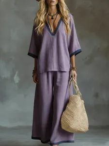 Elegant two-piece purple summer set featuring a V-neck top and matching wide-leg pants