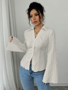 Close-up of elegant white V-neck pleated shirt with flared sleeves and button-down detail