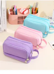 Three large-capacity double-layer canvas pencil cases in pastel blue, pink, and purple.