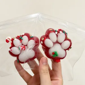 Close-up detail of Christmas cat paw squishy toys in clear bags for stress relief