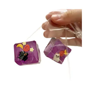Handcrafted Halloween themed purple glitter cube squeeze toys for stress relief and sensory fun.