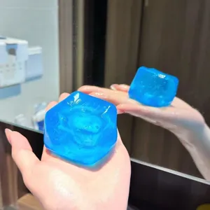 Close-up of a blue ice cube squishy toy showing its transparent and soft texture.