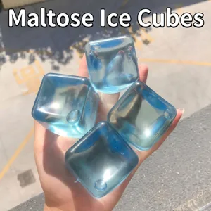 Transparent blue maltose ice cube squishy stress relief toy for sensory play held in hand