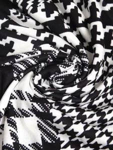 Macro view showing the soft texture of classic black and white houndstooth knit fabric