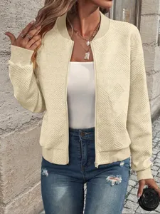 Close-up detail showing the textured diamond knit pattern on this beige zip-up bomber jacket