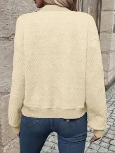 Back view detail of beige women's textured jacket with baseball collar and ribbed hem