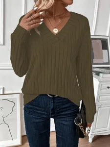 Close-up detail of olive green V-neck ribbed knit sweater with elegant gold necklaces