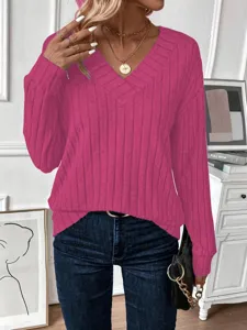 Close-up of a vibrant magenta long sleeve V-neck ribbed knit sweater for women