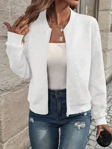 Close-up detail of white textured zip-up bomber jacket with elegant geometric pattern
