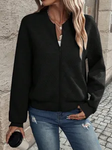 Detailed view of women's black bomber jacket with diamond texture and front zipper.