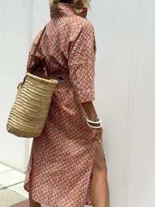Detailed macro view of orange geometric pattern shirt dress with high side slit