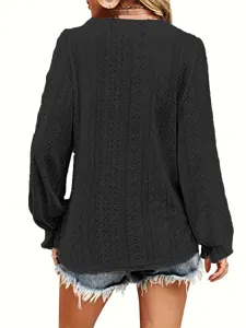 Detailed back view of a black long sleeve eyelet embroidered top with pleated sleeves
