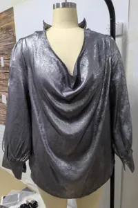 Front view of metallic silver deep V-neck long sleeve satin blouse on a mannequin