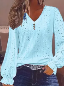 Close-up of sky blue V-neck top featuring intricate eyelet hollow-out details and ruffles.
