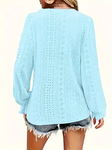 Back view of light blue long-sleeved top with delicate eyelet embroidery details