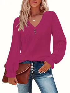 Detailed view of magenta V-neck top with eyelet texture and ruffled cuffs