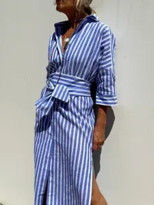 Side detail view of a stylish blue and white striped shirt dress with a waist tie