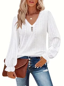 Detailed view of white eyelet hollow blouse with pleated flared cuffs and button V-neckline