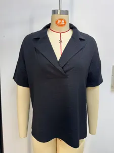 Close-up of black short sleeve polo shirt with lapel collar and textured fabric
