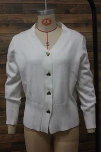 Detailed view of a white knitted V-neck cardigan with decorative golden heart buttons