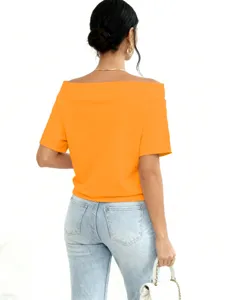 Stylish back view of a vibrant orange off-the-shoulder casual loose sweatshirt for women