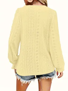 Back view of elegant yellow hollow-out long sleeve top featuring delicate textured fabric