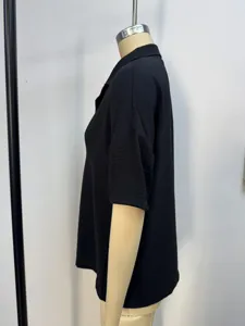 Side view of women's loose short-sleeve black polo shirt on a mannequin