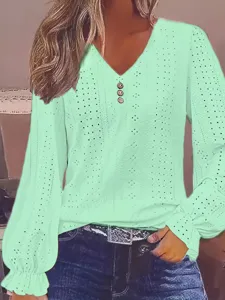 Macro detail of mint green V-neck top showing eyelet hollow out pattern and ruffled sleeves