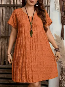 Macro view of terracotta V-neck loose dress showing crinkled texture and boho jewelry