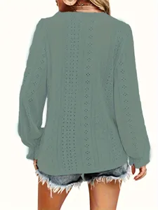 Close-up back view showing the eyelet texture and pleated cuff detail of the mint green top