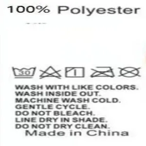 Detail shot of care label for 100% polyester cargo pants with wash instructions
