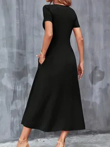 Detail view of the back and functional side pocket on a black casual short sleeve midi dress