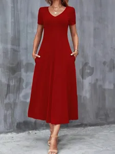 Detail view of an elegant red short sleeve V-neck maxi dress with functional pockets