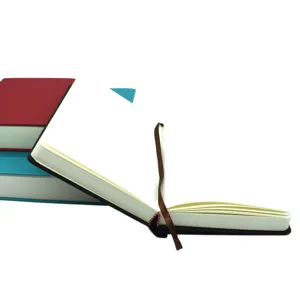 Detailed macro view of open thick blank sketchbook with brown ribbon bookmark
