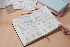 Vista dettagliata di un'agenda inglese 2026 aperta con attività scritte a mano e tracker