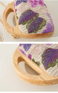 Close-up view of floral sequin embroidery and solid wood handle on a woven evening bag