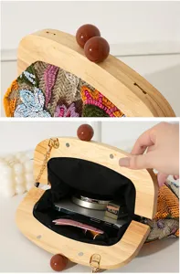 Detail view showing the wooden frame and interior capacity of the embroidered clutch bag