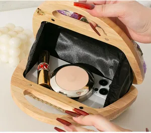 Detailed interior view of embroidered straw evening bag with wooden handle capacity