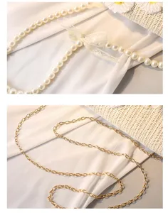 Detailansicht der Perlenkette mit Spitzenschleife und der goldenen Metallkette für die Strohtasche