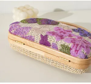Close-up of elegant solid wood evening bag with floral embroidery and sequins