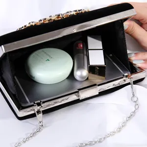 Elegant velvet evening clutch with rhinestones showing spacious interior capacity
