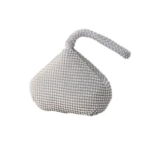 Close-up detail of luxurious silver rhinestone evening clutch bag with unique teardrop design