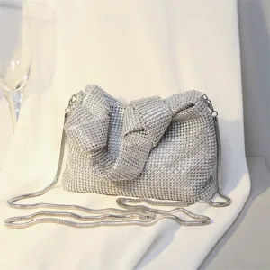 Silver sparkling rhinestone evening bag with knot detail and silver snake chain strap