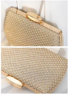 Close-up detail of a gold box evening clutch bag featuring glitter finish and rhinestone grid