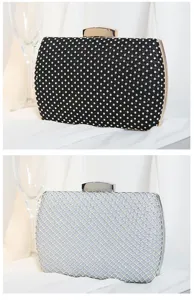 Elegant close-up view of black and silver rhinestone-studded box clutch bags for banquets