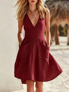 Detailed view of a burgundy sleeveless cotton linen dress with large front pockets