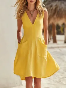 Detailed close-up of a yellow cotton-linen V-neck sleeveless dress with large front pockets