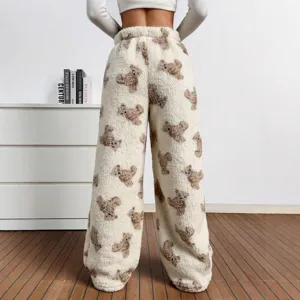 Detail view of cozy women's fuzzy wide-leg pants featuring a cute teddy bear pattern