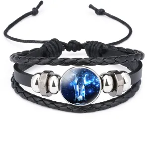 Close-up of braided leather bracelet with galaxy elephant glass cabochon charm
